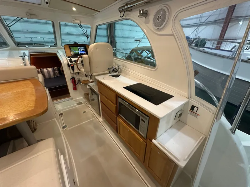 Slide: The Image of 2018 Back Cove 32 yacht interior with modern kitchen and navigation area. - 4
