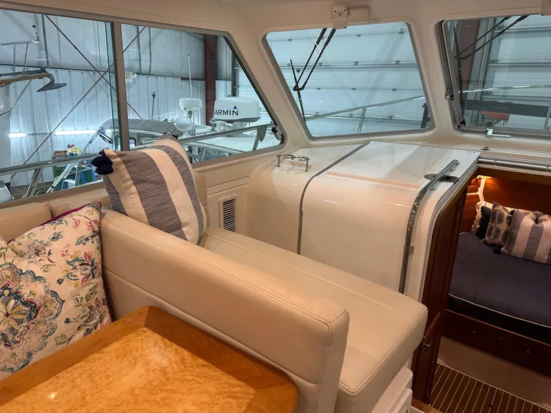 Slide: The Image of Interior of 2018 Back Cove 32 yacht with plush seating and elegant wooden table. - 6