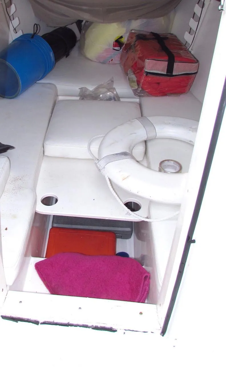Slide: The Image of Interior of a 2005 Marlago F35 boat with life preserver and storage items. - 12