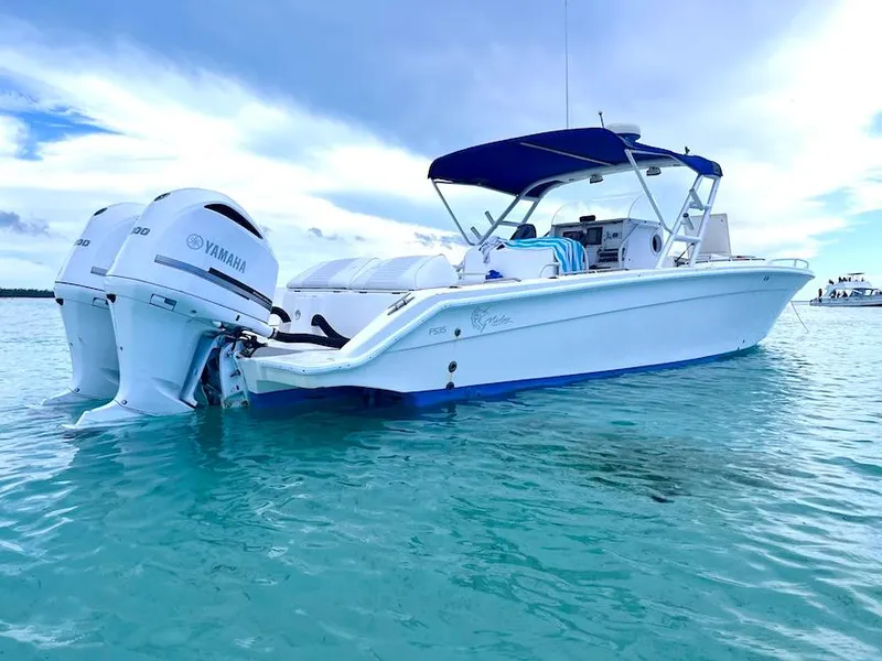 Slide: The Image of 2005 Marlago F35 boat with Yamaha engines on clear blue water. - 2