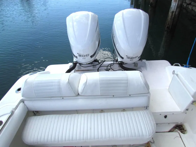 Slide: The Image of Marlago F35 2005 boat with twin outboard engines and white seating, docked by the water. - 3