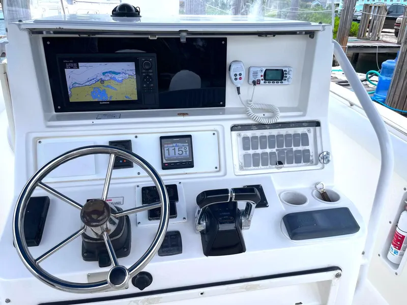 Slide: The Image of Control panel of a 2005 Marlago F35 boat with navigation equipment and steering wheel. - 6