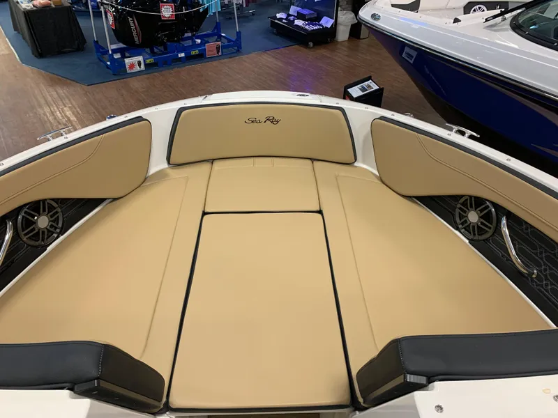 Slide: The Image of 2025 Sea Ray SPX 210 boat interior with tan seating and sleek design. - 10