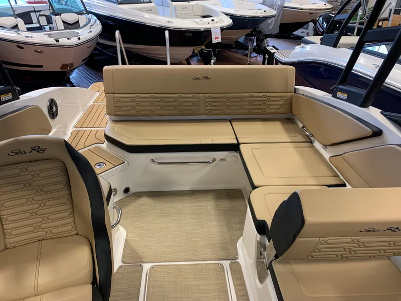 Slide: The Image of 2025 Sea Ray SPX 210 boat interior with beige seating and modern design. - 11