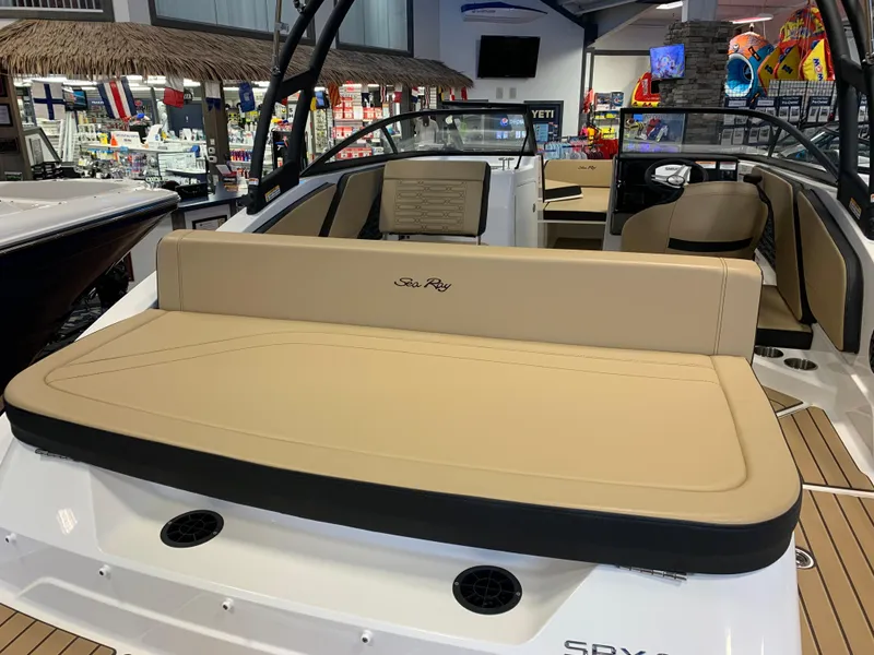 Slide: The Image of 2025 Sea Ray SPX 210 boat interior with tan seating and modern design. - 3