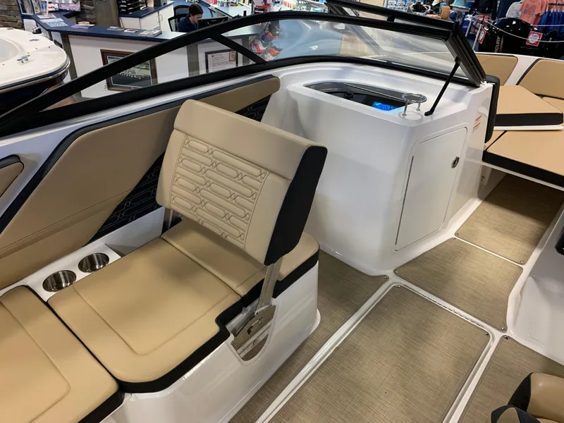 Slide: The Image of 2025 Sea Ray SPX 210 boat interior with beige seating and modern design. - 6