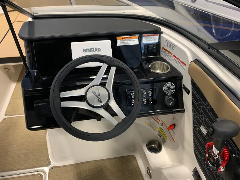 Slide: The Image of 2025 Sea Ray SPX 210 boat dashboard with steering wheel and Simrad display. - 8
