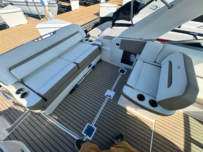 Slide: The Image of 2016 Regal 32 Express boat interior with cushioned seating and cup holders. - 10