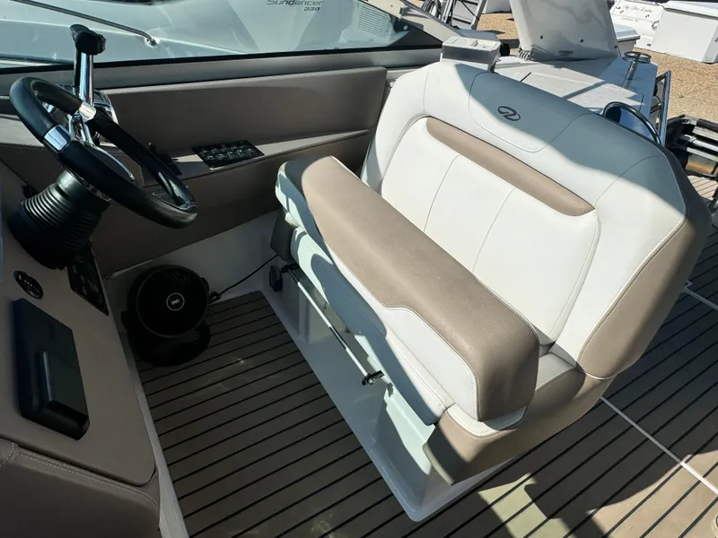 Slide: The Image of Helm seat of 2016 Regal 32 Express boat with steering wheel and controls. - 14