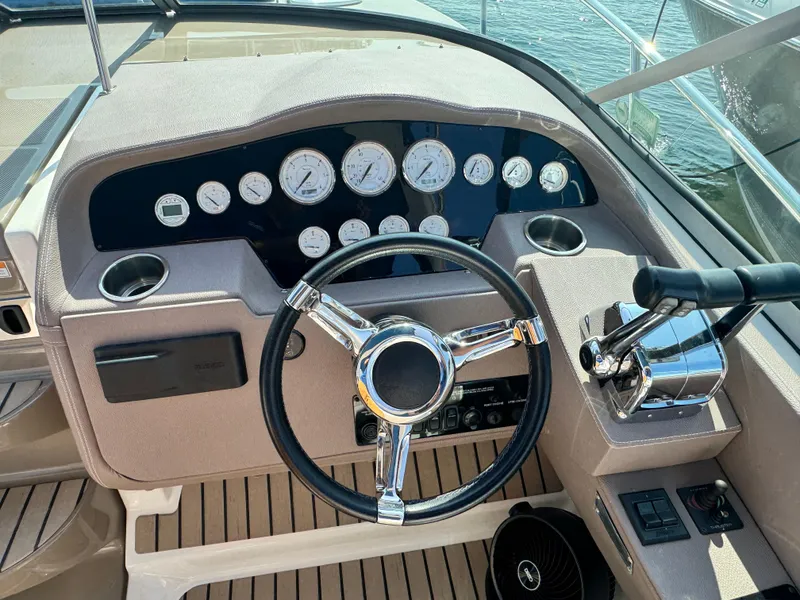 Slide: The Image of Helm of 2016 Regal 32 Express boat with steering wheel and control panel. - 15