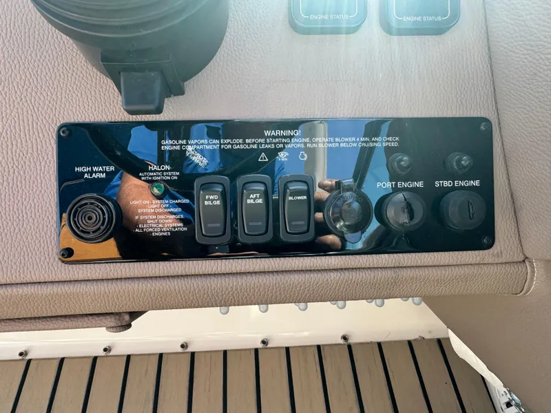 Slide: The Image of Control panel of a 2016 Regal 32 Express boat with various switches and warnings. - 17