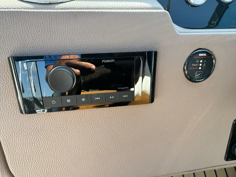 Slide: The Image of Control panel of a 2016 Regal 32 Express boat with audio and gas detector. - 18