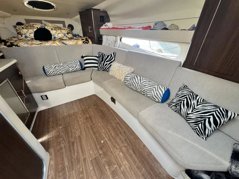 Slide: The Image of Interior of a 2016 Regal 32 Express boat with stylish seating and zebra-patterned pillows. - 21