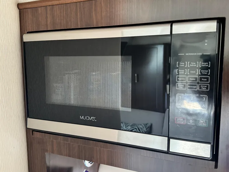 Slide: The Image of Built-in microwave oven in 2016 Regal 32 Express boat kitchen. - 23