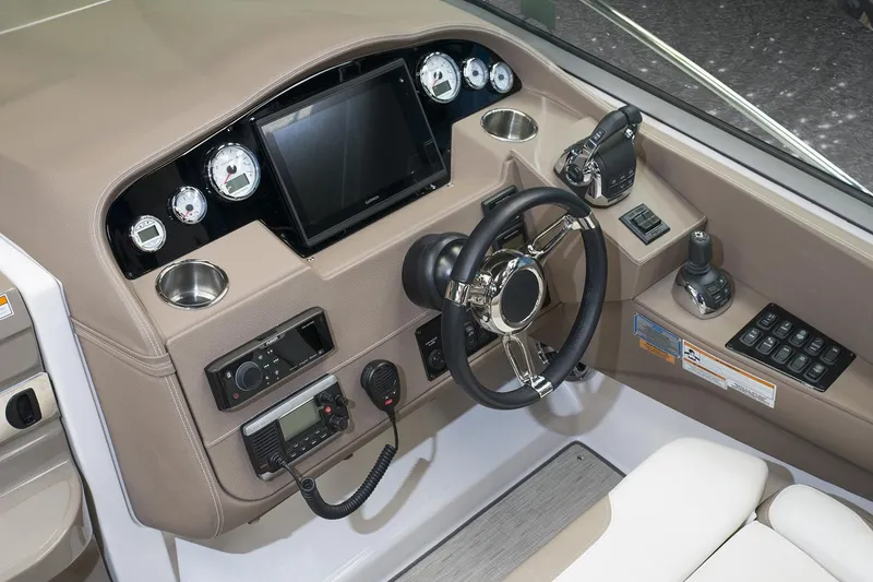 Slide: The Image of 2016 Regal 32 Express helm with steering wheel, gauges, and navigation controls. - 35