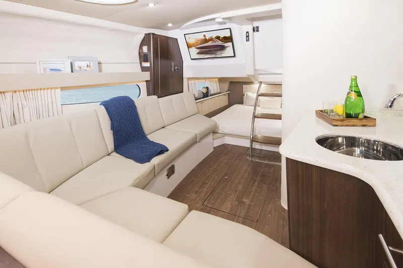 Slide: The Image of Luxurious interior of 2016 Regal 32 Express yacht with modern seating and kitchenette. - 37