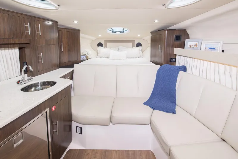 Slide: The Image of Luxurious interior of 2016 Regal 32 Express yacht with modern kitchen and cozy seating. - 38