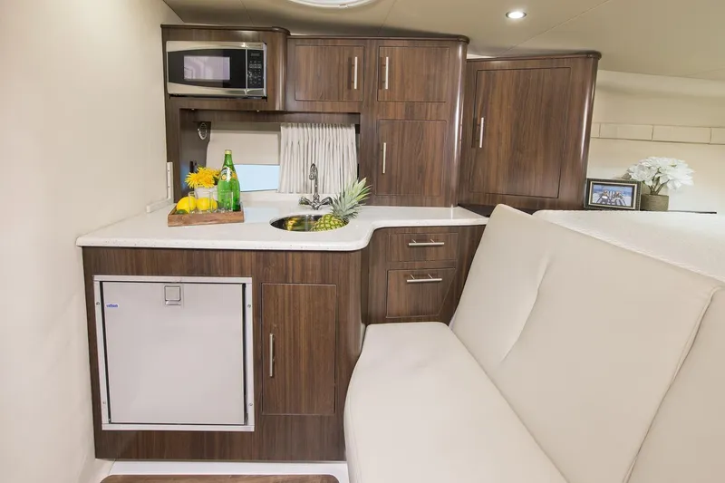 Slide: The Image of Luxurious interior of 2016 Regal 32 Express yacht with kitchenette and seating area. - 39
