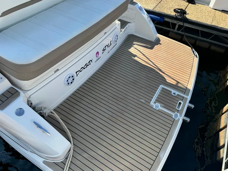 Slide: The Image of 2016 Regal 32 Express boat with teak swim platform and cushioned seating. - 4