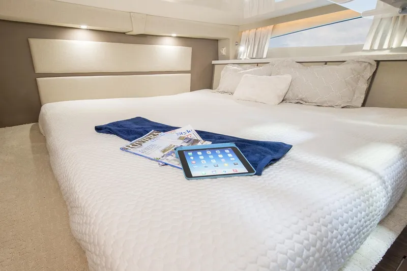 Slide: The Image of Luxurious interior of 2016 Regal 32 Express yacht with cozy bed and tablet. - 40