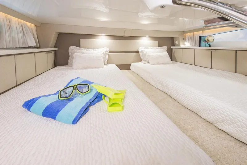 Slide: The Image of Interior of 2016 Regal 32 Express yacht with twin beds and snorkeling gear. - 41
