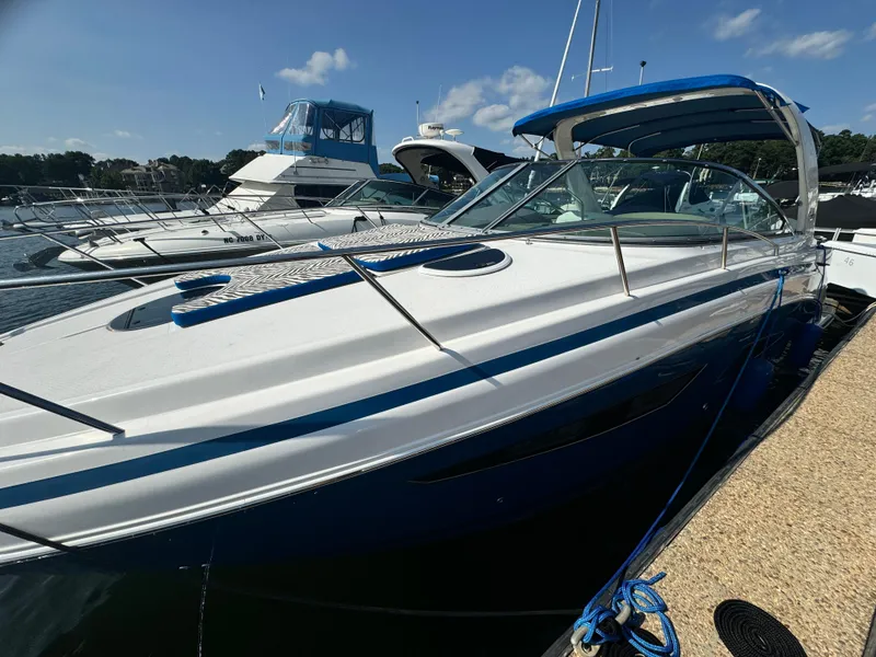 Slide: The Image of 2016 Regal 32 Express boat docked at marina under clear blue sky. - 5