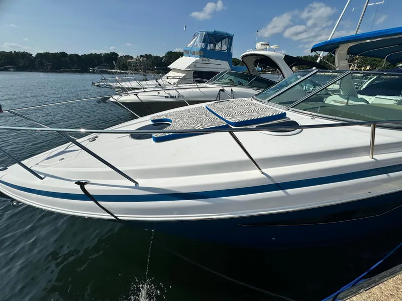 Slide: The Image of 2016 Regal 32 Express boat docked on a sunny day, surrounded by other boats. - 6