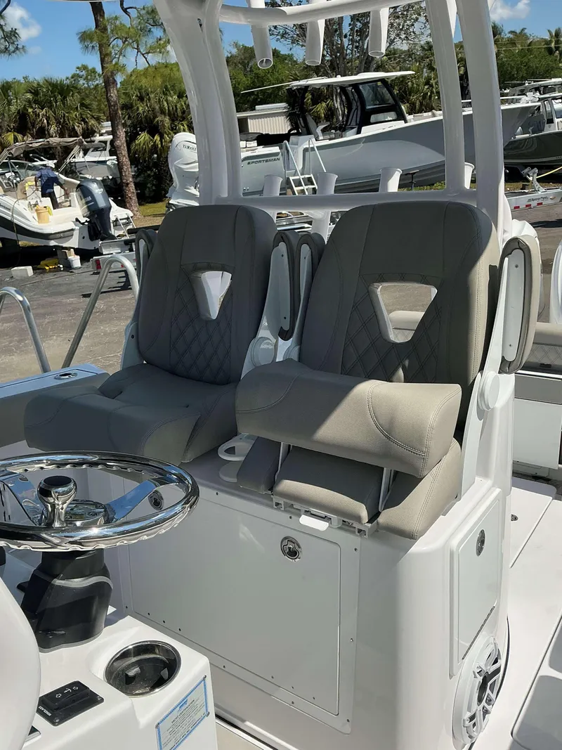 Slide: The Image of 2025 Sportsman 282 Open boat interior with dual cushioned seats and steering wheel. - 10
