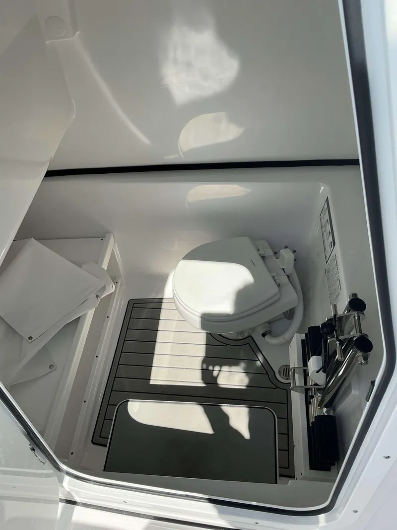 Slide: The Image of 2025 Sportsman 282 Open boat interior with compact marine toilet. - 13