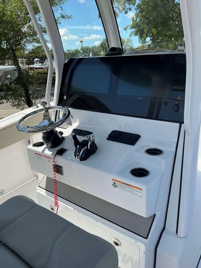 Slide: The Image of Helm of 2025 Sportsman 282 Open boat with steering wheel and controls. - 15