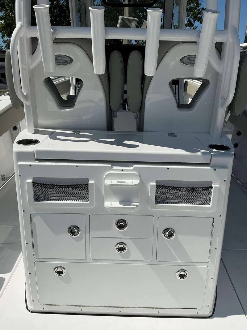 Slide: The Image of 2025 Sportsman 282 Open boat console with storage drawers and rod holders. - 21