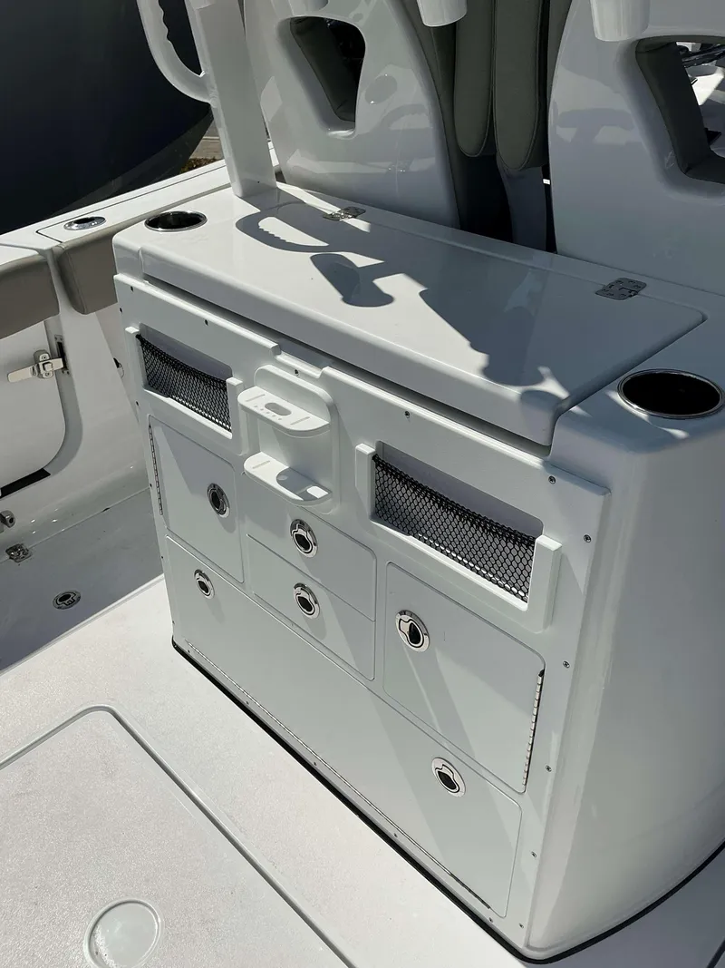 Slide: The Image of 2025 Sportsman 282 Open boat console with storage compartments and cup holders. - 24
