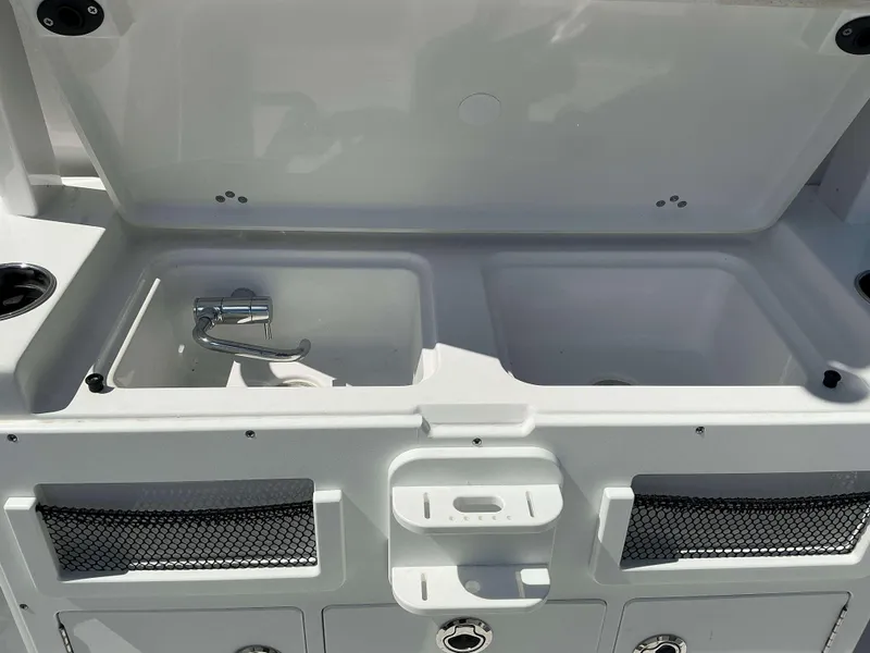 Slide: The Image of 2025 Sportsman 282 Open boat sink and storage area with open lid. - 25