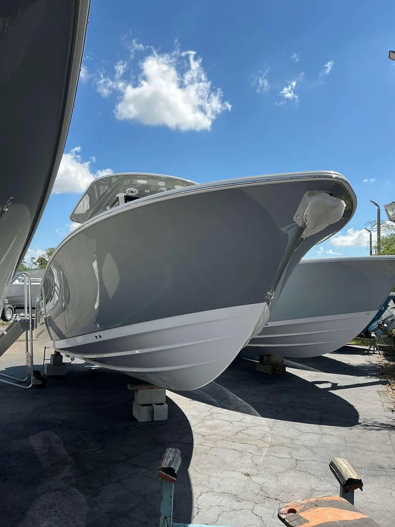 Slide: The Image of 2025 Sportsman 282 Open boat on display under a clear blue sky. - 5