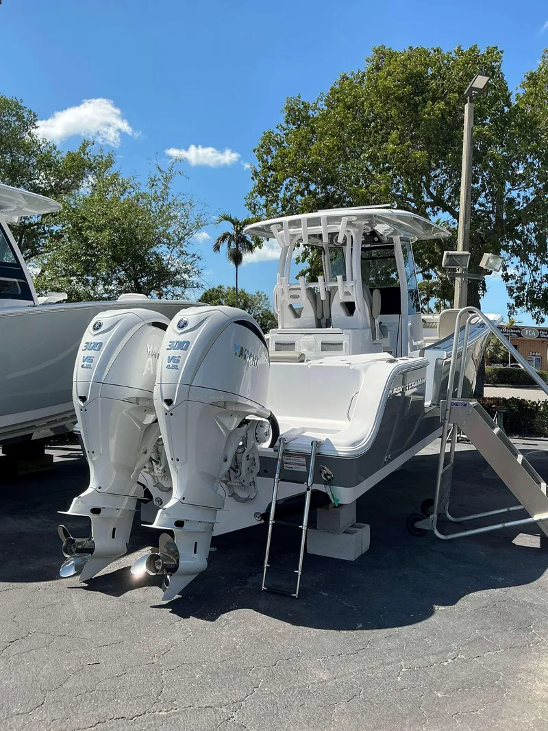 Slide: The Image of 2025 Sportsman 282 Open boat with dual Yamaha 300 engines, parked outdoors. - 7