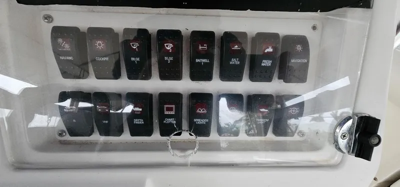 Slide: The Image of Control panel of a 2003 Jefferson Marlago FS35 boat with labeled switches. - 11