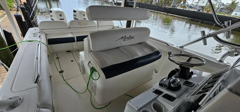 Slide: The Image of 2003 Jefferson Marlago FS35 boat interior with seating and steering wheel by the water. - 12