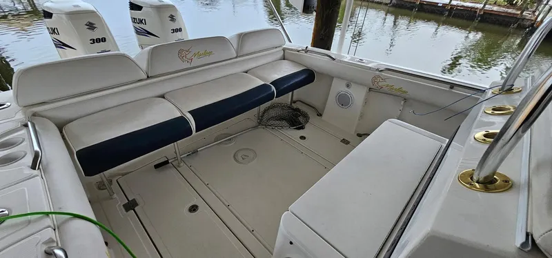 Slide: The Image of 2003 Jefferson Marlago FS35 boat interior with seating and Suzuki engines. - 15