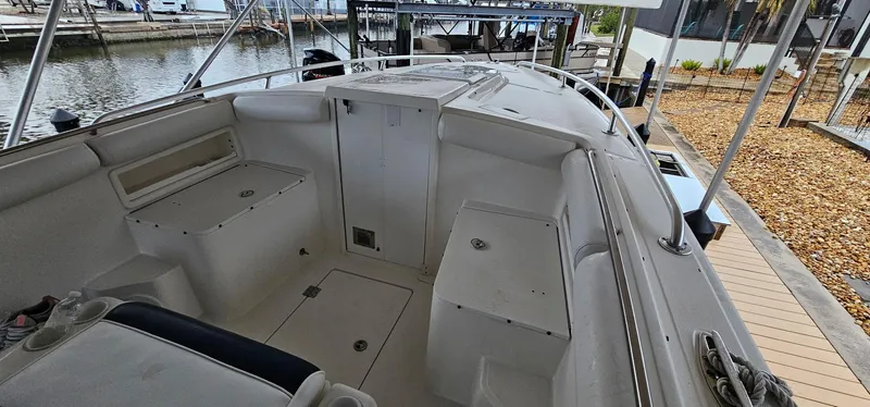 Slide: The Image of 2003 Jefferson Marlago FS35 boat interior, featuring spacious seating and storage, docked by the water. - 17