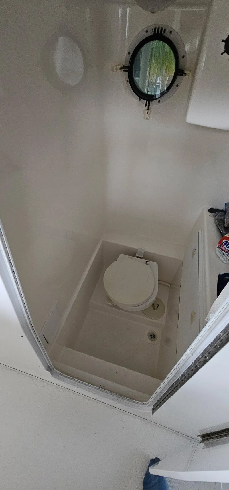 Slide: The Image of 2003 Jefferson Marlago FS35 boat bathroom with porthole and compact toilet. - 18