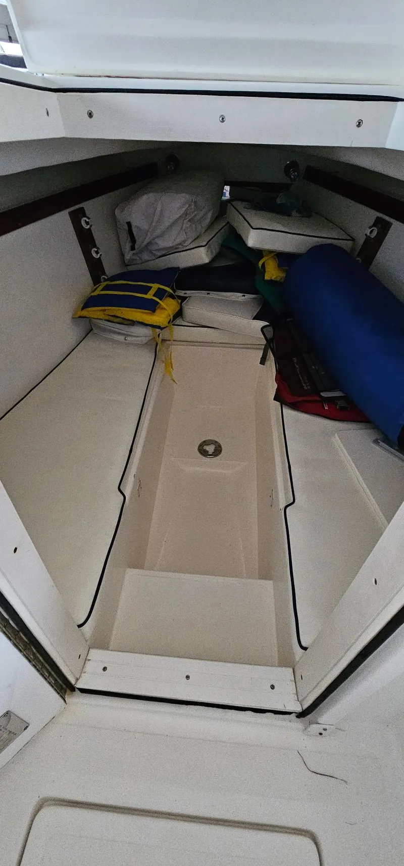 Slide: The Image of 2003 Jefferson Marlago FS35 boat cabin interior with storage and cushions. - 19