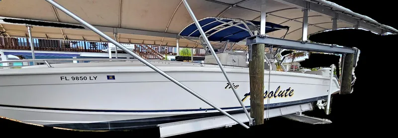 Slide: The Image of 2003 Jefferson Marlago FS35 boat docked under a canopy. - 3