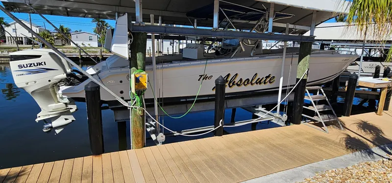 Slide: The Image of 2003 Jefferson Marlago FS35 boat named "The Absolute" docked with Suzuki engine. - 4