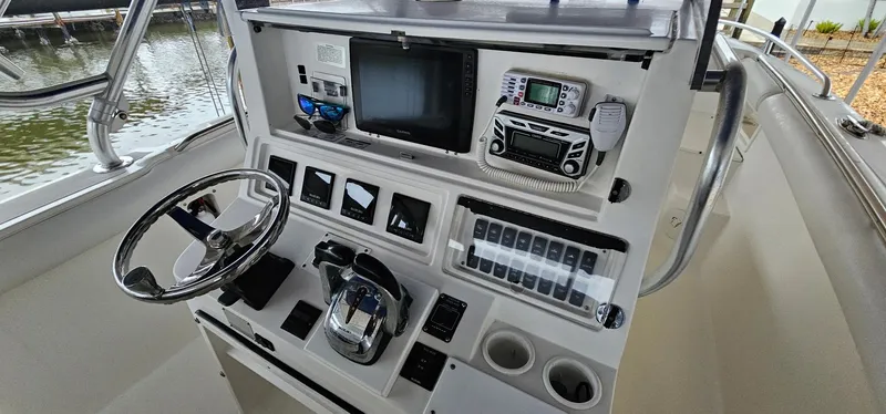 Slide: The Image of Control panel of 2003 Jefferson Marlago FS35 boat with steering wheel and navigation equipment. - 8