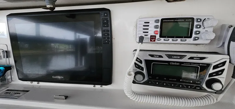 Slide: The Image of 2003 Jefferson Marlago FS35 boat dashboard with Garmin and Clarion electronics. - 9