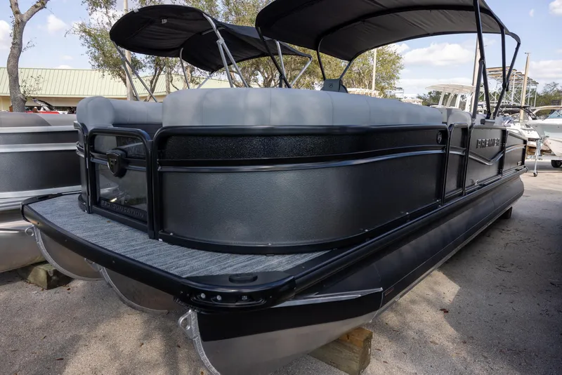 The Image of 2025 Premier 230 Sunsation RS pontoon boat with sleek black design and canopy. - 0