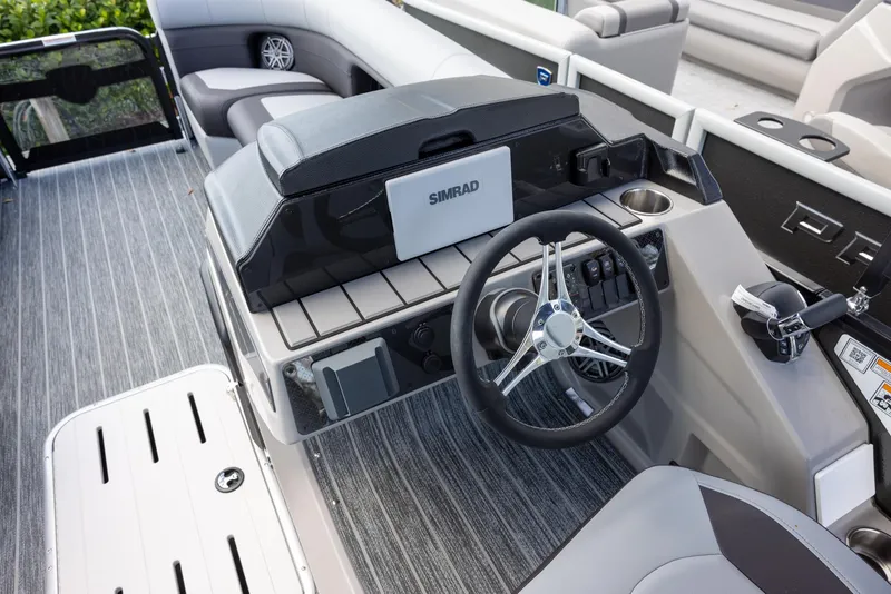 Slide: The Image of 2025 Premier 230 Sunsation RS boat interior with steering wheel and Simrad display. - 9