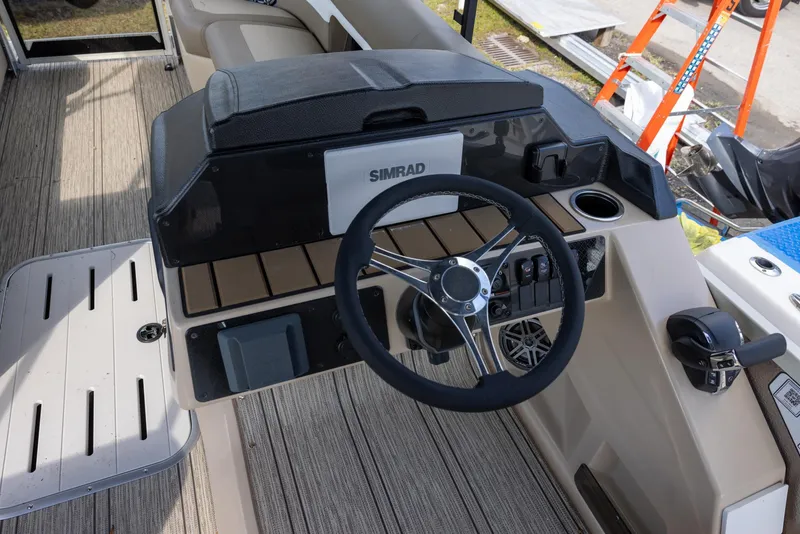 Slide: The Image of 2025 Premier 250 Sunsation RS boat dashboard with steering wheel and Simrad display. - 13