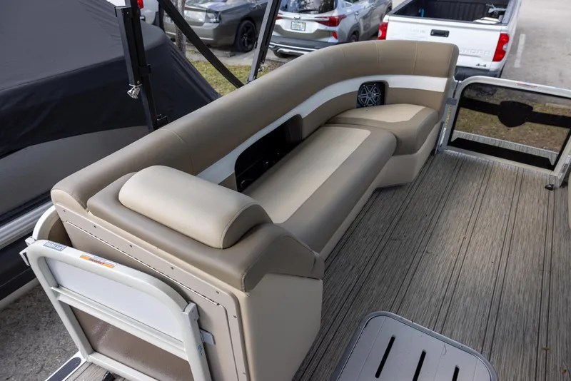 Slide: The Image of 2025 Premier 250 Sunsation RS boat interior with beige seating and wood-style flooring. - 6