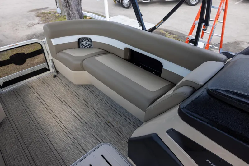 Slide: The Image of 2025 Premier 250 Sunsation RS boat interior with beige seating and wood-style flooring. - 7